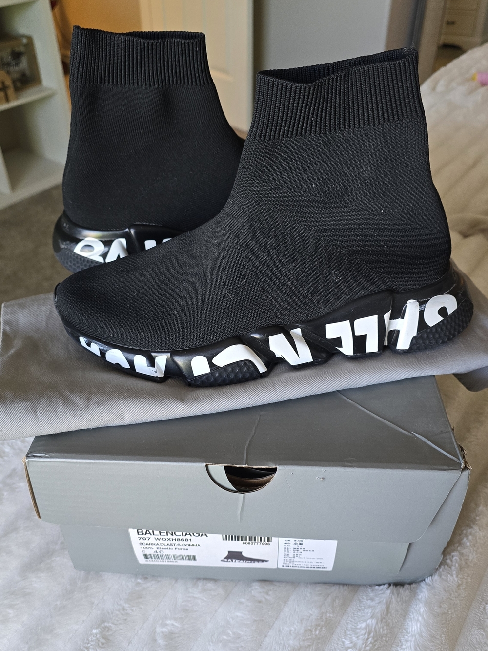 These are authentic Balenciaga Speed Graffiti Sneakers in black and white.